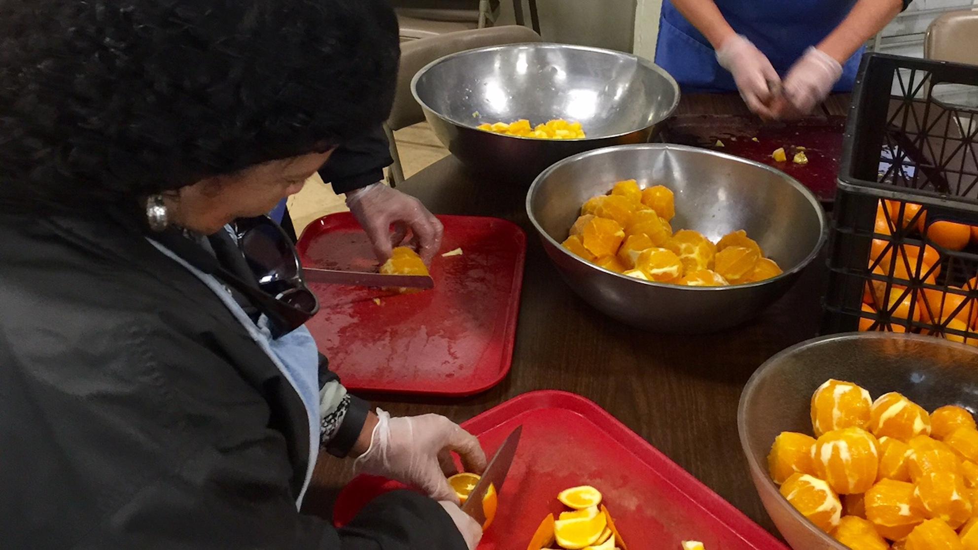 SJW employees chopping oranges