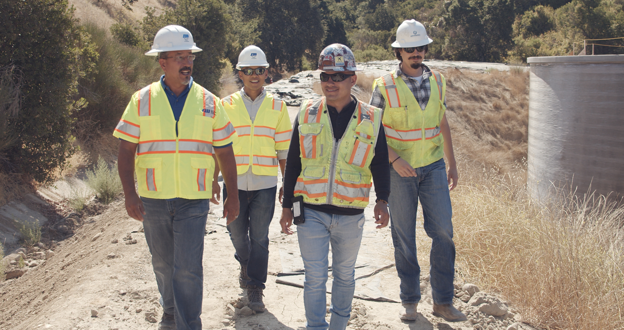 Four San Jose Water engineers walking through an outdoor facility