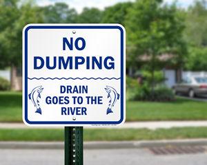 Sign that says No Dumping: drain goes to the river