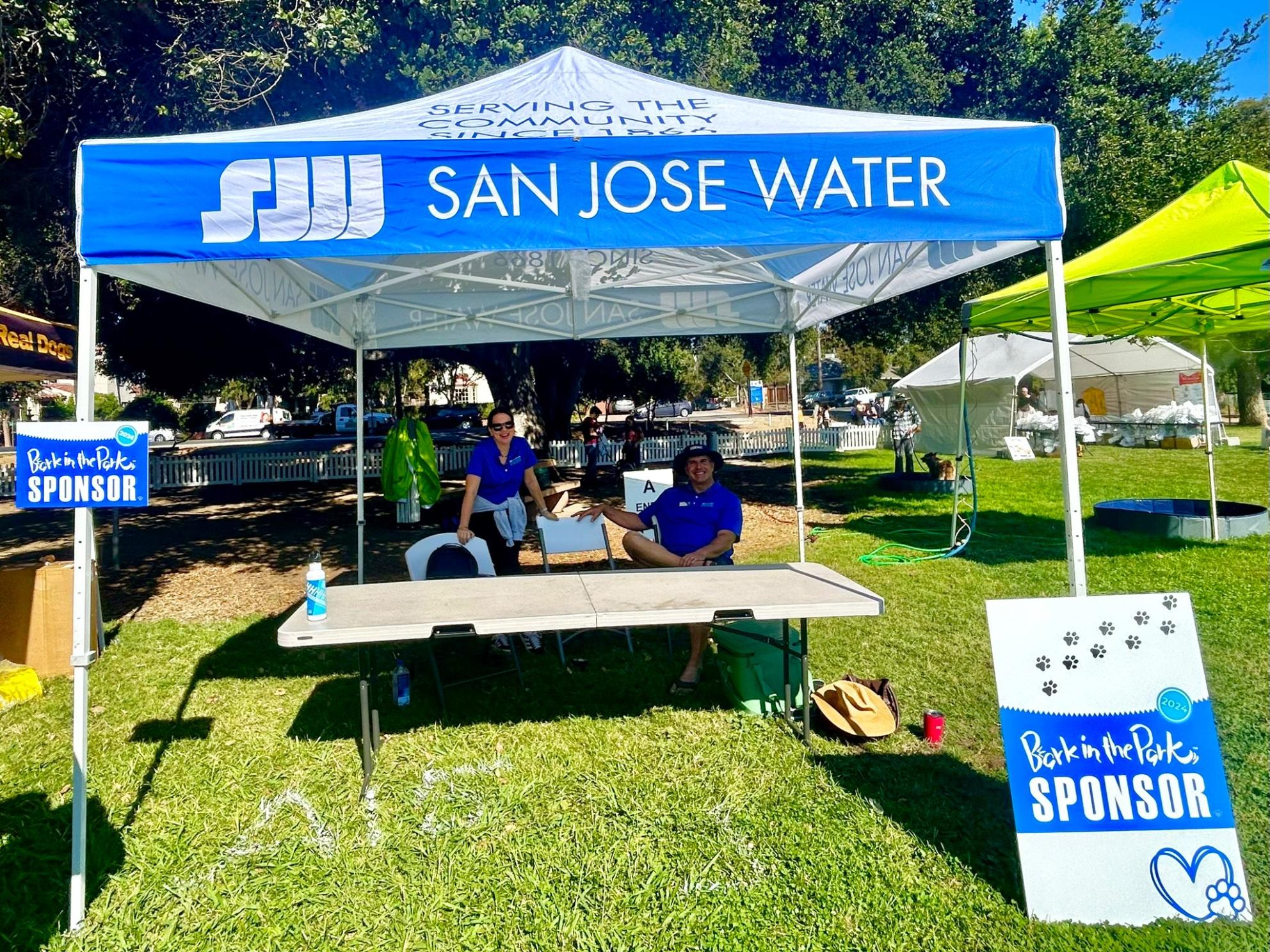 Two SJW staff members at Bark in the Park sponsor booth