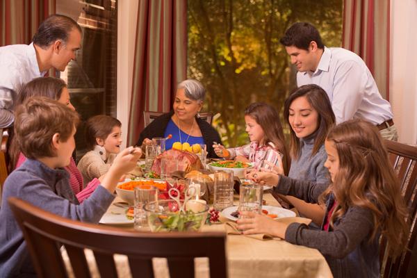 Multigenerational family at a dining table having dinner together